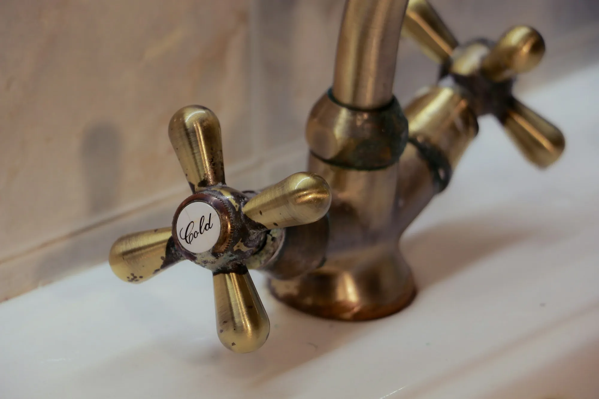 Scale Prevention & Water Heater Protection in Aliso Viejo, CA Antique brass faucet with hot and cold handles