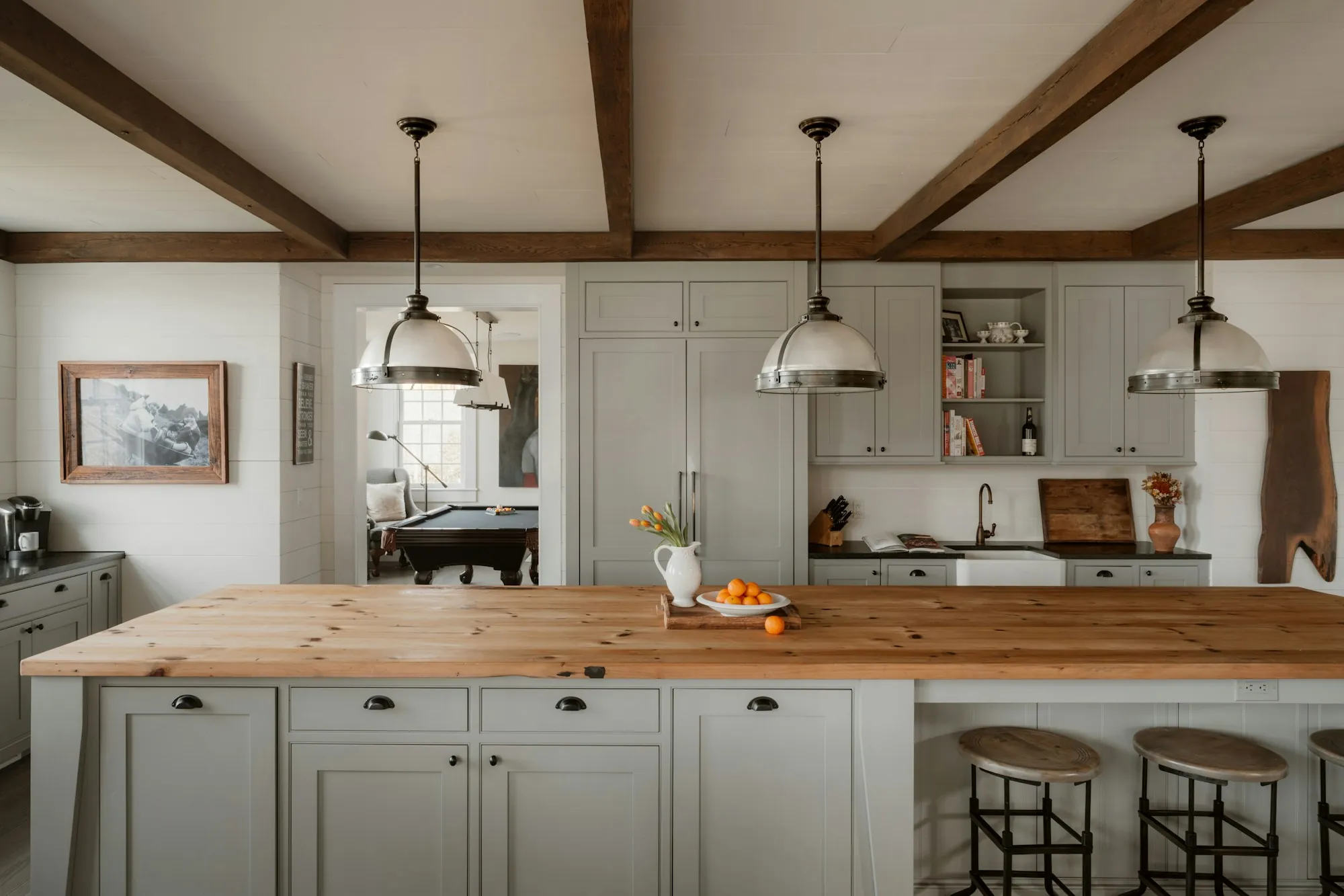 Your Neighbors in South County Water Treatment Farmhouse kitchen with a wooden island and pendant lights