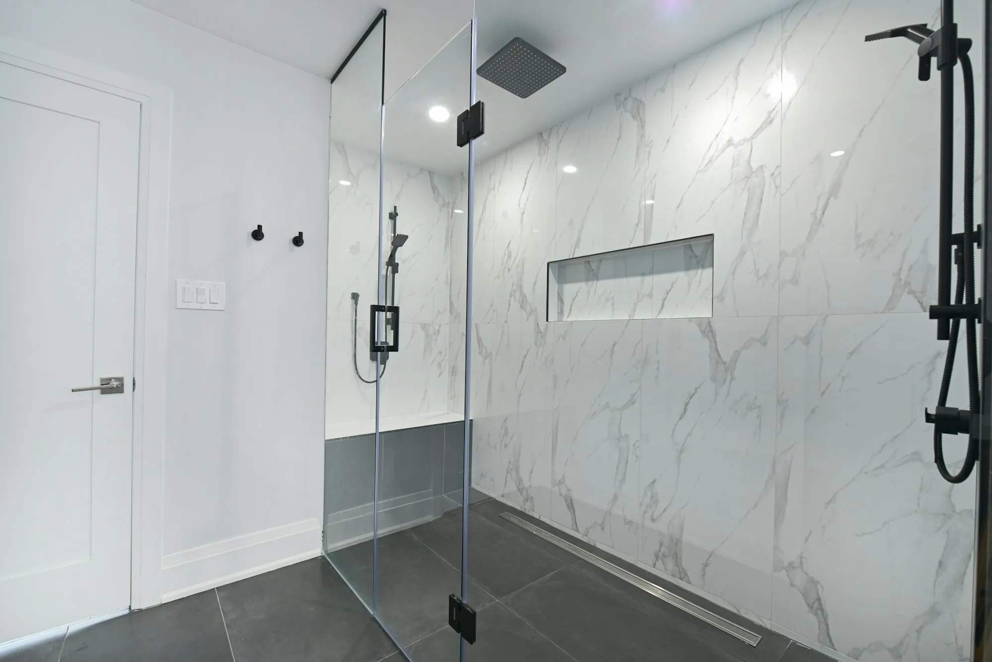 Salt-Free Water Conditioners in Aliso Viejo, CA Modern bathroom with a glass-enclosed shower and marble walls