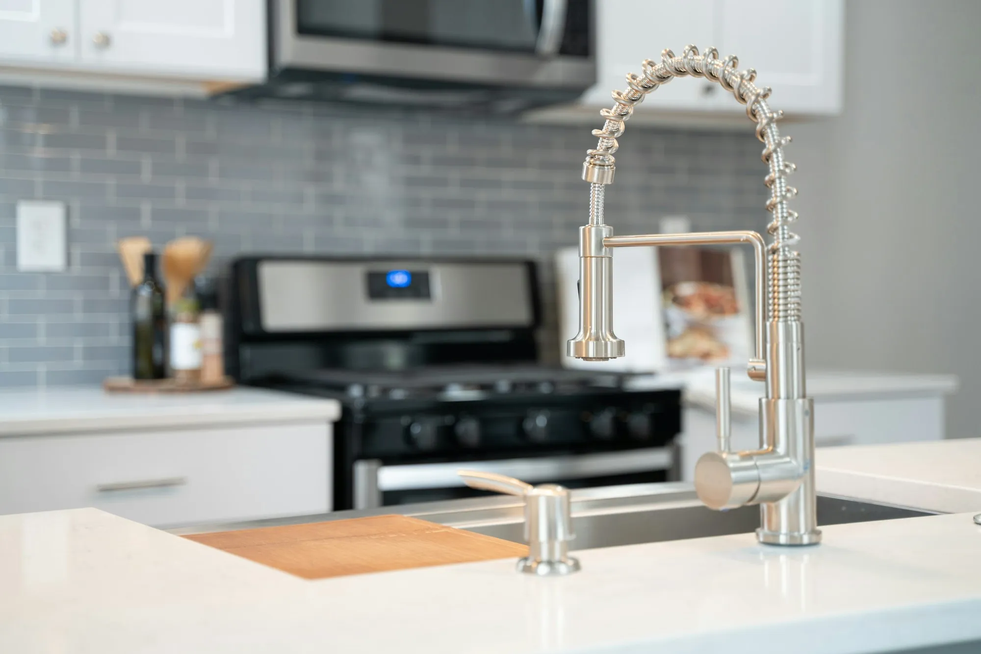 Water Filtration Services in Aliso Viejo, CA Pull-down kitchen faucet in front of a gas range