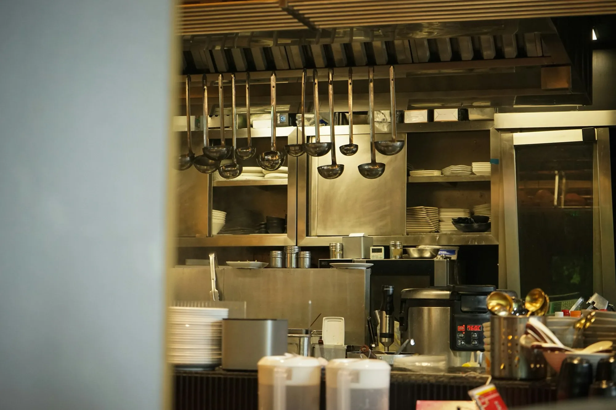 Commercial Water Filtration in Aliso Viejo, CA Utensils hanging in a stainless steel professional kitchen