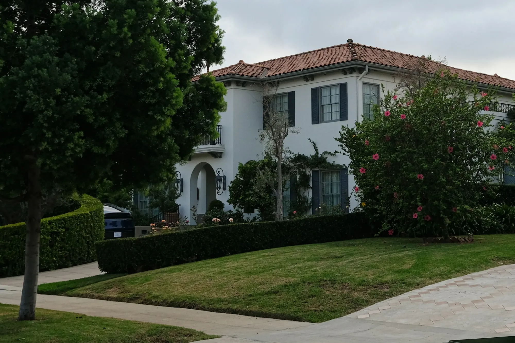 Contact Aliso Viejo Water Systems Large white house with a tiled roof and a green lawn