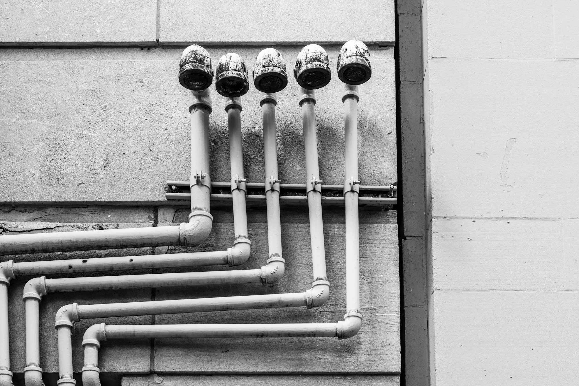 Why Aliso Viejo Homeowners Start Here White water supply pipes with valves on a wall